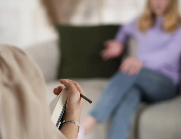 sided-view-young-girl-talking-therapist